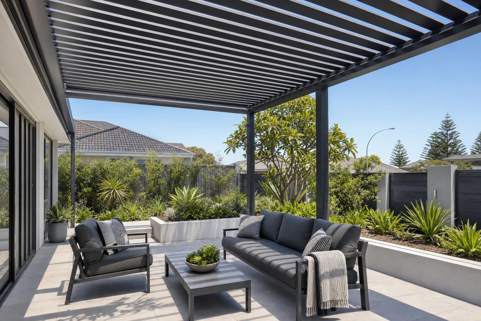 Open slatted aluminium pergola over an outdoor lounge in Joondalup